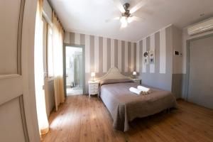 a bedroom with a bed with two towels on it at Hotel Volta in Padova