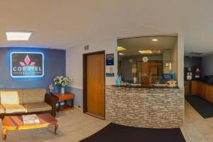 a lobby of a hotel with a counter and a waiting room at Coratel Inn & Suites by Jasper Hastings in Hastings