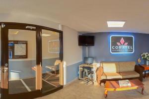 a lobby with a waiting room with a sign on the wall at Coratel Inn & Suites by Jasper Hastings in Hastings