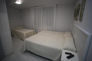 Postel nebo postele na pokoji v ubytování Hostal Santa Barbara