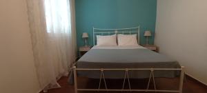A bed or beds in a room at Sweet Maisonette in Corfu Town