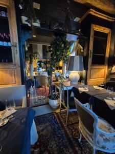 a dining room with tables and chairs and a table with glasses at Elena House Apartments in Viareggio