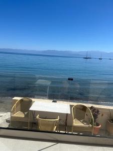 a table and chairs with a view of the water at ANGELA APARTMENT in Koroni +8 photos