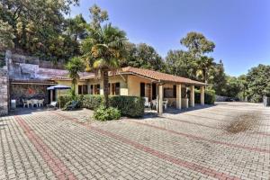 a house with a brick driveway in front of it at Casa Helba - Colle Paradiso Experience in Capoliveri