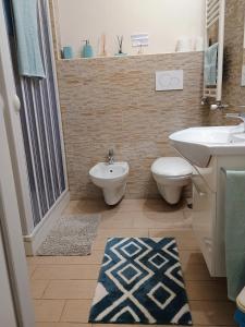 a bathroom with a sink and a toilet and a sink at Sole&Mare in Monopoli