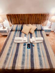 a bedroom with a large bed with two pillows at Il Maestrale in La Maddalena