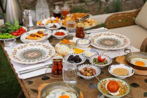 a table topped with plates of food and bowls of food at Aşiyan Yalısı in İznik