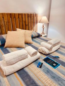 a bed with two pillows and towels on it at Il Maestrale in La Maddalena