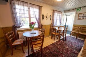 a dining room with two tables and chairs at Liekorannan Majatalo- kodinomaista majoitusta rautatieasemaa vastapäätä in Sastamala