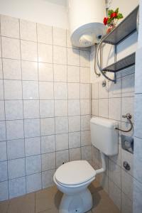 a bathroom with a white toilet in a room at Studio apartment Kasalo in Kaštela