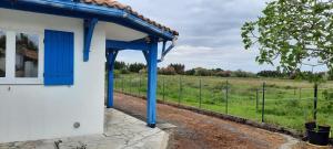 a blue door on a building next to a field at Chez Jeannot et Jeannette in Allards +8 photos