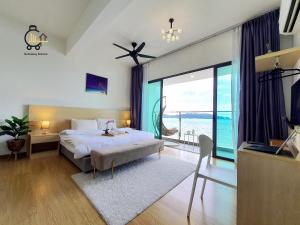 a bedroom with a bed and a view of the ocean at 1 min to Seaview & Sunrise Heart of Kuantan in Kuantan +153 photos