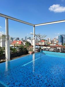 a swimming pool with a view of the city at Monsoon Bassac Hotel in Phnom Penh