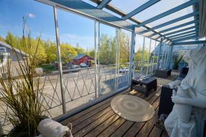 a screened in porch with a view of a parking lot at Liekorannan Majatalo- kodinomaista majoitusta rautatieasemaa vastapäätä in Sastamala