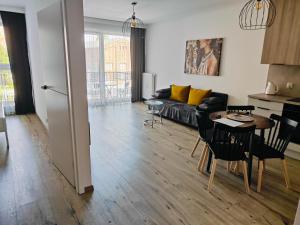a living room with a couch and a table at Red Kot Lisia 12 in Zielona Góra