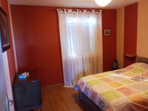 a bedroom with a bed and a window at Maison 6 personnes Billom in Billom