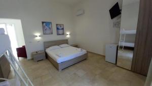 a bedroom with a bed and a television in it at B&B Bonomi in Torre Lapillo