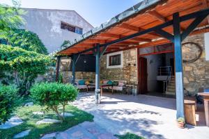 an outdoor patio with a wooden pergola at Armagrandi Hotel Bozcaada-Special Category in Bozcaada