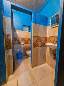 a bathroom with a toilet and a sink at Bohol Sea Breeze Cottages and Resort in Panglao