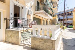 a white railing on a building with a no parking sign at Doris House by GuestCorfu in Corfu Town