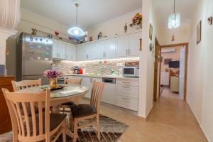 a kitchen with a table and chairs and a refrigerator at Doris House by GuestCorfu in Corfu Town