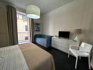 a bedroom with a bed and a couch and a television at Casa Garibaldi in Trapani +60 photos