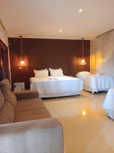 a hotel room with two beds and a couch at Pousada Gostoso Paradise in São Miguel do Gostoso +75 photos