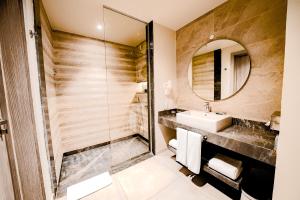 a bathroom with a sink and a mirror at SENTIDO Reef Oasis Suakin Resort in Marsa Alam City
