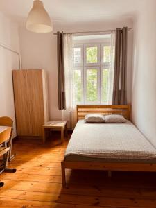 a bedroom with a bed and a window at Lilia House in Poznań