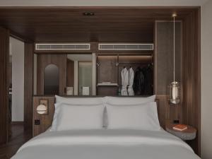 バンコクにあるPublic House Hotel - Sukhumvit 31のベッドルーム(大型ベッド1台、クローゼット付)