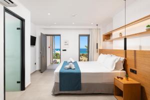 a bedroom with a bed with a view of the ocean at Diamond Star Hotel in Falasarna +37 photos