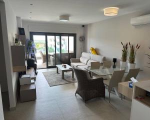a living room with a couch and a table at Oasis Beach 13 Casa del Guardamar in Alicante