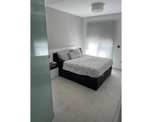 a bedroom with a bed and a glass wall at Oasis Beach 13 Casa del Guardamar in Alicante