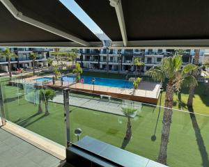 a view of a pool from the balcony of a apartment at Oasis Beach 13 Casa del Guardamar in Alicante