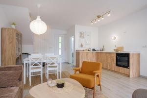 a living room and kitchen with a table and chairs at Piramida Visoko in Visoko