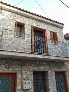an old stone building with a balcony at Jenny's House II in Skiathos Town +21 photos