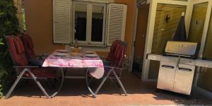a table with chairs and a laptop on a patio at Villa AnaAngela in Malinska
