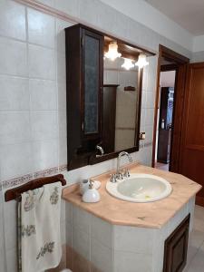 a bathroom with a sink and a mirror at Casa Paola in Assemini