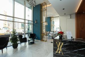 a lobby with chairs and a reception desk in a building at Apartments Lux sea view in Budva
