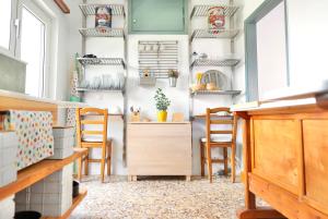a room with chairs and shelves on the wall at A-ma-ru-to in Amarynthos