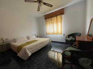 a bedroom with a large bed and a window at O Entre Mar y Montaña in Almería