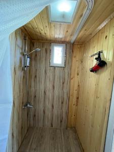 a wood paneled shower in a tiny house at Bazaletis Akvani 