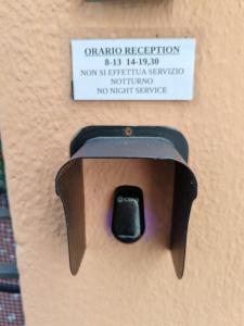 an electric outlet with a sign on a wall at Hotel Triestina in Noli +59 photos