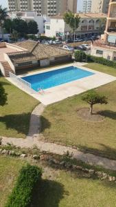 a large swimming pool in the middle of a city at Apt Erisa en Torremolinos dos min de la playa, Puerto Marina in Torremolinos