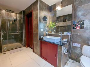 a bathroom with a sink and a shower at Beachfront Magic Villa - by KohChangVillas in Ko Chang