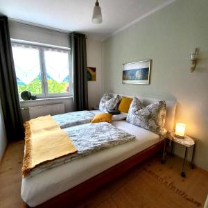 a bedroom with a large bed with a window at Ferienwohnung Energie Oase in Millstatt