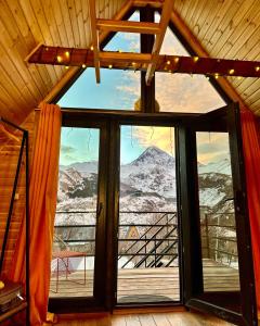 a window in a room with a view of a mountain at Kazbegi Kuro Cottages in Stepantsminda