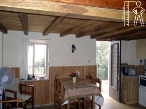 a kitchen and dining room with a table and chairs at Tsorni Hill Cottage in Lefokastro
