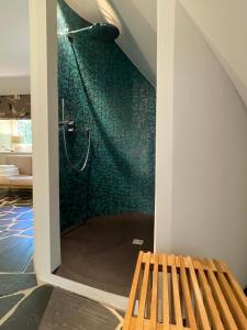 a bathroom with a shower with a wooden bench at VILLA HANSJÖRG FELMY in Nebel +89 photos
