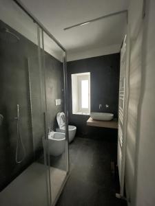 a bathroom with a shower and a toilet and a sink at Maison62 in San Severino Marche